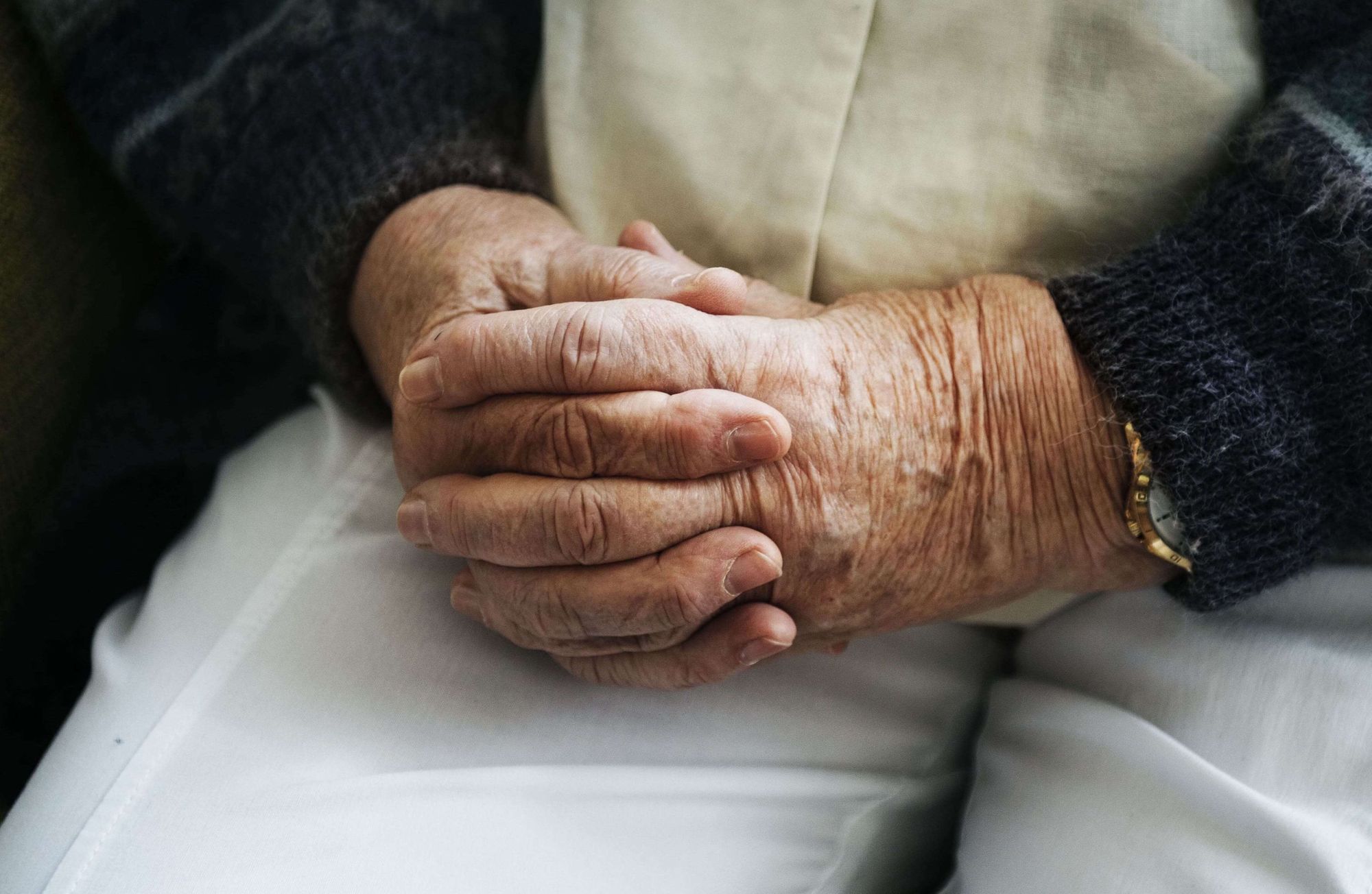Old person with clasped hands