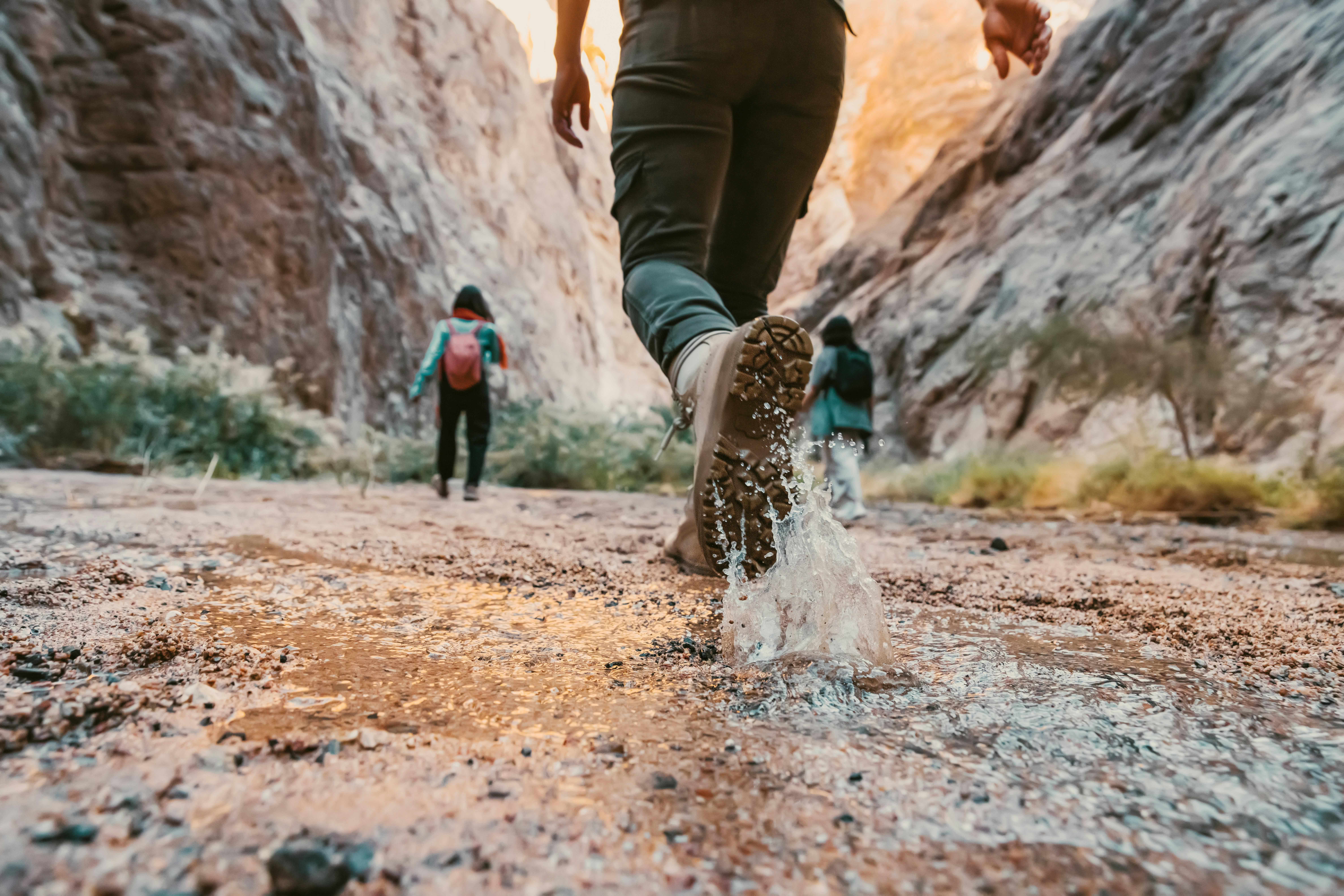 Hikers trekking in a river
